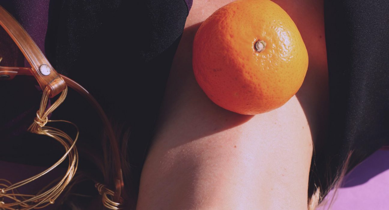 Woman with orange on her neck
