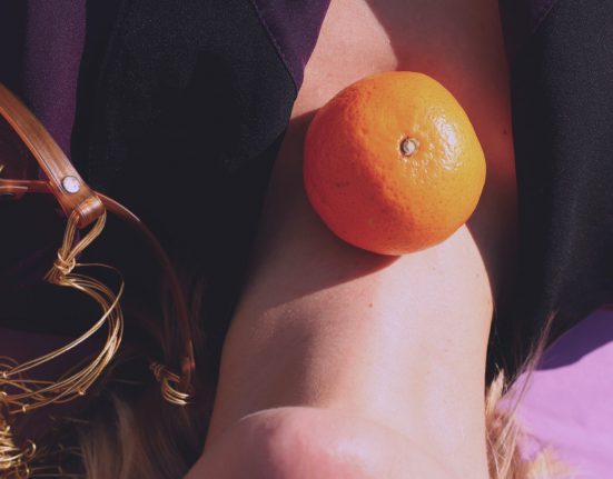 Woman with orange on her neck