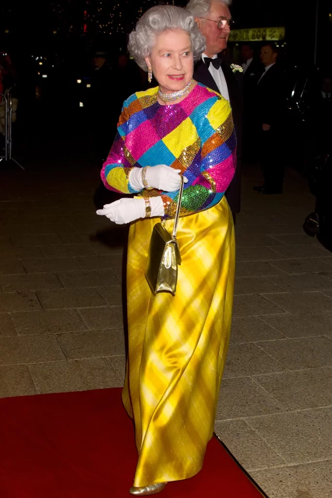 November 1999 Queen Elizabeth attended the Royal Variety Performance at the Birmingham Hippodrome wearing a colourful sequined top and striped gold skirt.